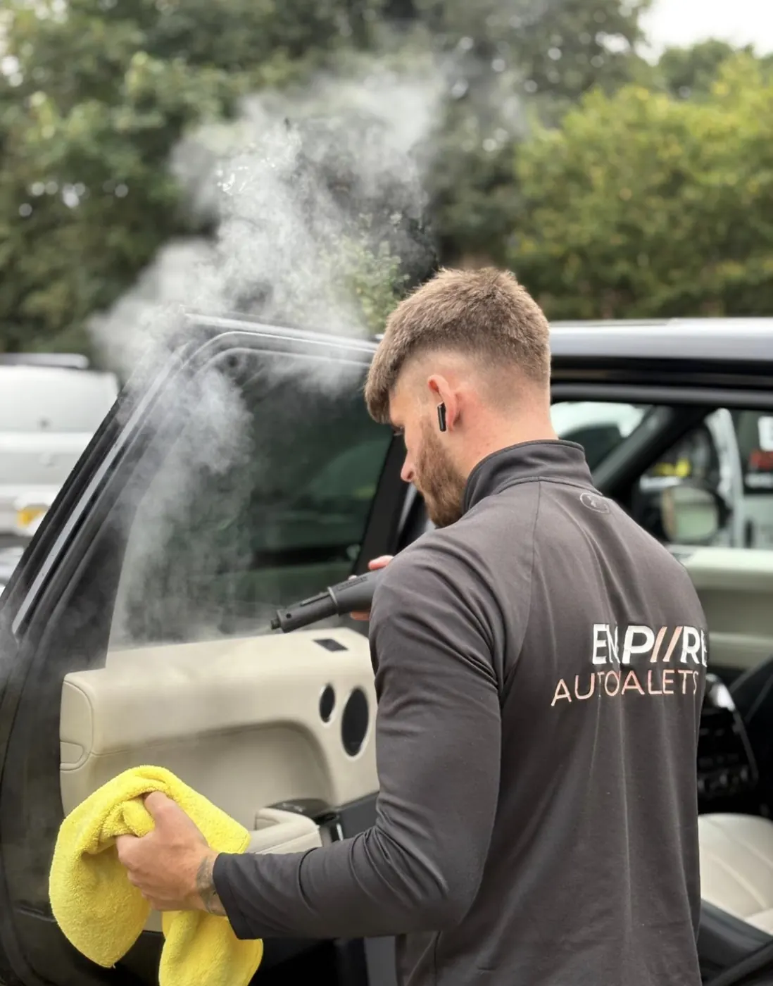 Brandon steam-cleaning a car interior