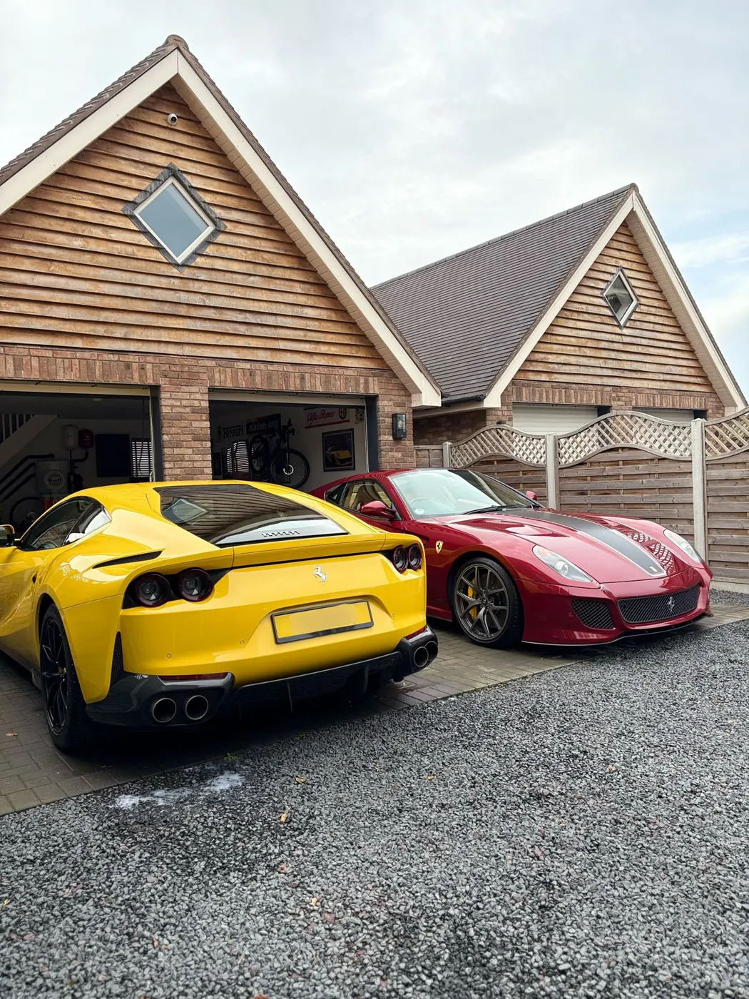 Porsche and Ferrari parked on a driveway